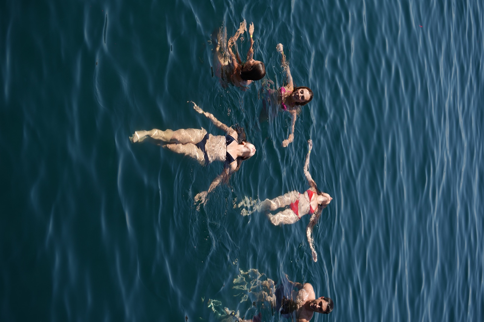Guests floating in the open sea at one of the swim stops